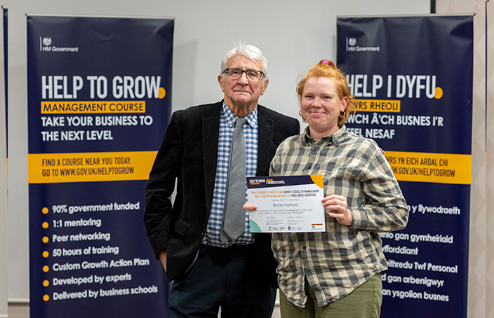 Becky From Benthyg Cymru holding a certificate presented by professor Brian Morgan